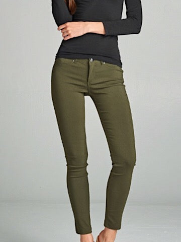 Olive green skinny jeans on a model.
