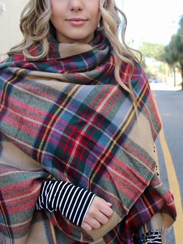 Plaid blanket scarf in red, green, and tan; cozy oversized design for fall.

