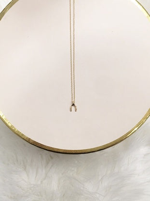 Gold Make a Wish necklace with delicate wishbone charm
