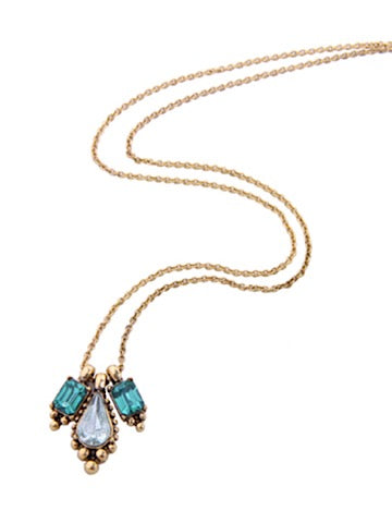 Gold chain necklace featuring a teardrop and emerald-cut crystal pendant.
