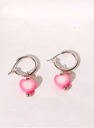 Pink heart dangle earrings with gold hoops.
