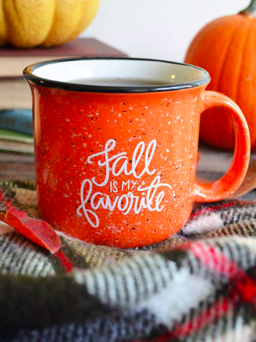 Orange "Fall is My Favorite" campfire mug, perfect for cozy autumn evenings.
