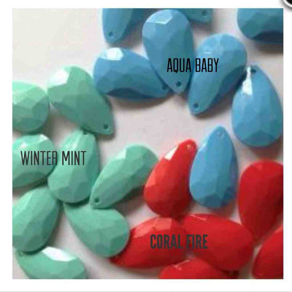 Teardrop-shaped necklace beads in aqua, mint, and coral.
