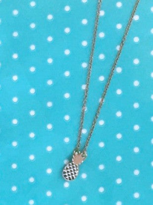 Silver Pineapple Charm Necklace on turquoise polka dot background
