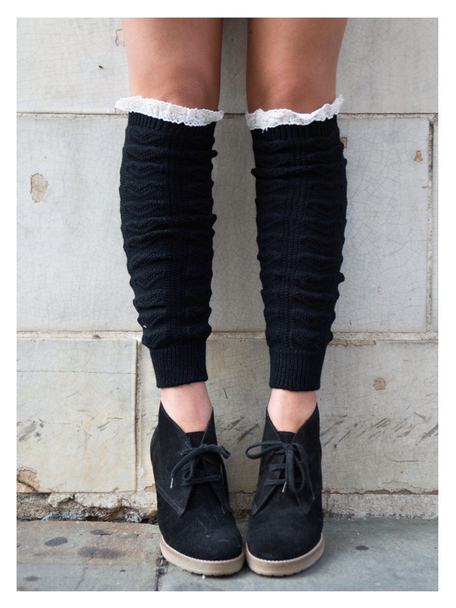 Black knitted leg warmers with lace trim; perfect for adding warmth and style.
