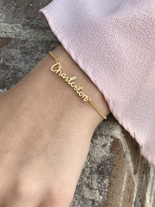 Gold Charleston name bracelet with delicate chain.
