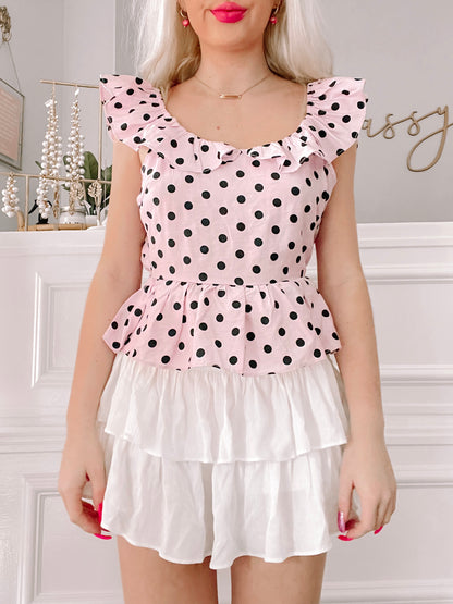 Pink & black polka dot Harper Dot Top with ruffled trim and layered white skirt.
