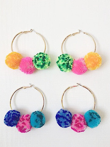 Festive in Fiji gold hoop earrings with three colorful pom-poms.
