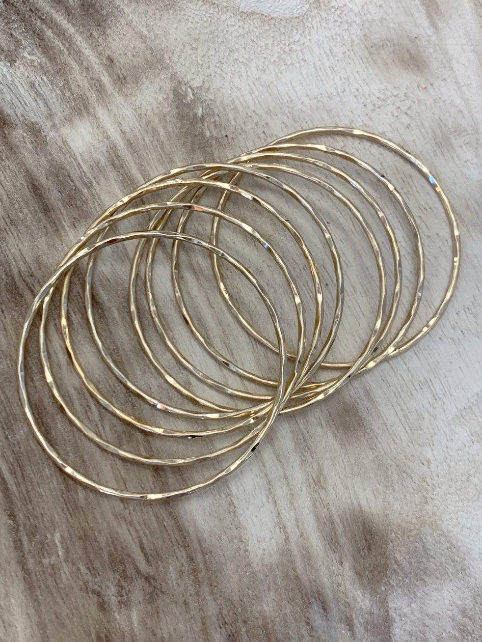 Gold bangle set of eight hammered gold bangles
