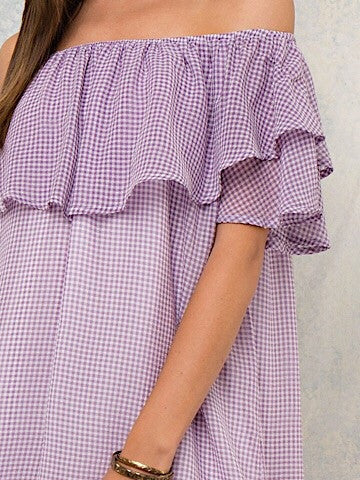 Lilac gingham off-shoulder dress with a ruffled neckline.
