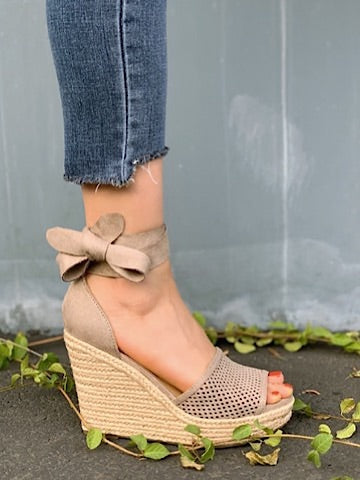 Beige One Step Closer wedges with bow detail & jute espadrille sole.
