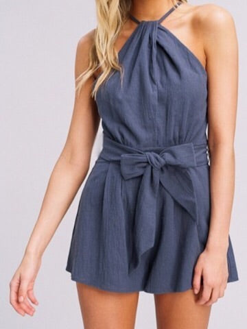 Blue halter romper with a self-tie waist, perfect for summer.
