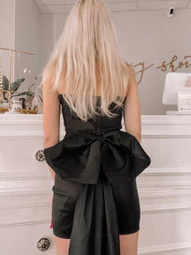 Black Showtime dress with large back bow detail

