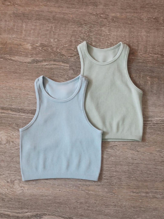 Seamless ribbed tank tops in light blue and mint green; perfect for layering.
