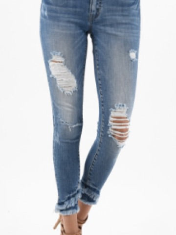 Light wash distressed jeans with frayed hems
