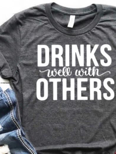 Dark gray tee shirt with "Drinks well with others" in white lettering.
