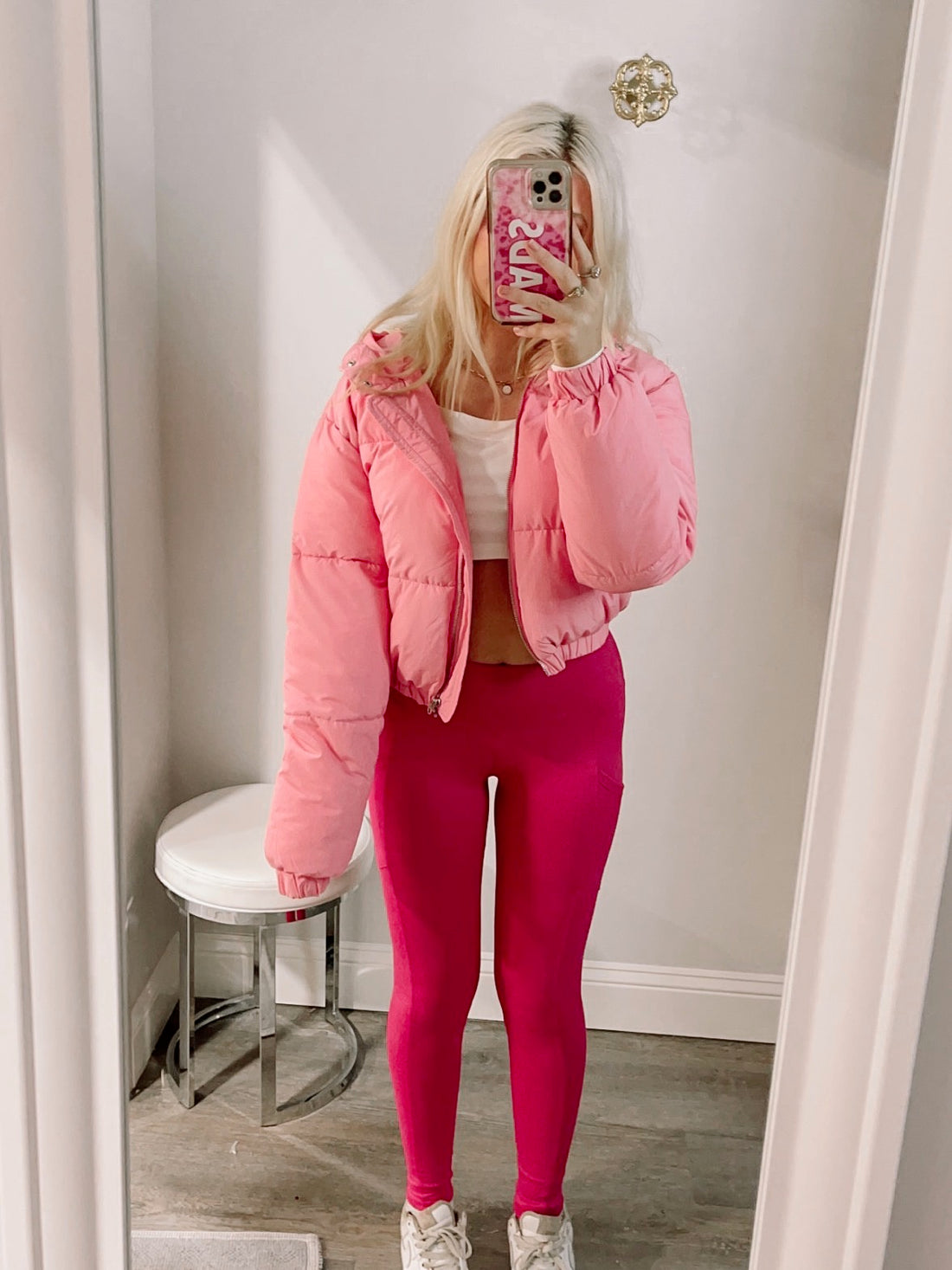 Pink puffer jacket styled with hot pink leggings in a dressing room mirror - candyland puffer jacket in pink from sassy shortcake
