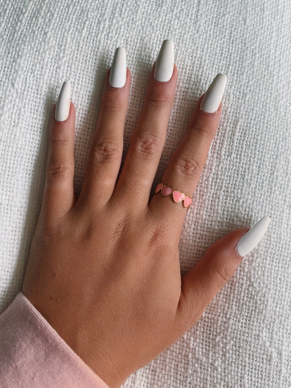 Gold ring featuring pink heart accents; Live to Love ring design.
