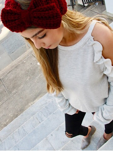 Crocheted burgundy bow headband for women, warm winter accessory.
