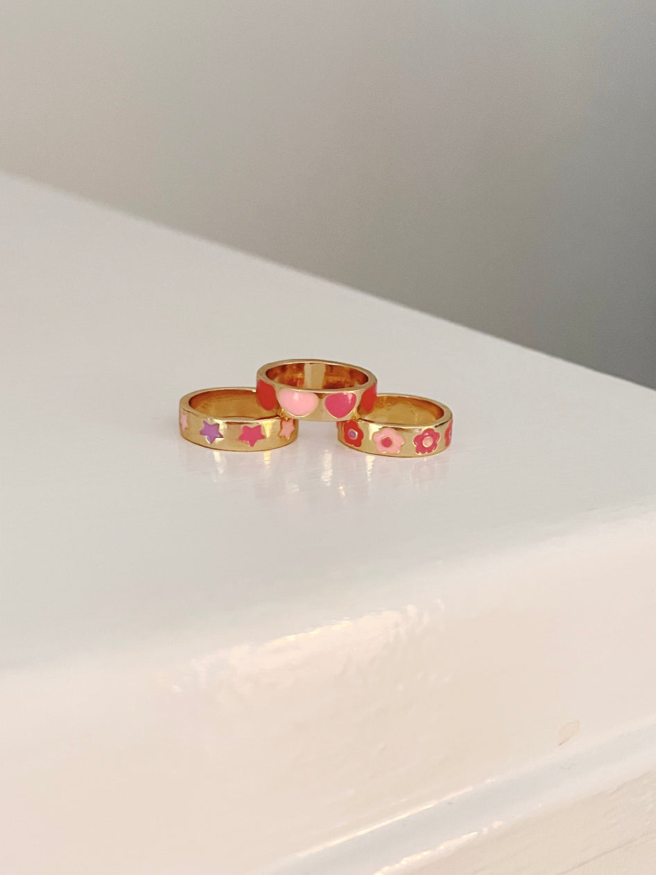 Gold Ring It On Trio: 3 enamel rings with stars, hearts & flowers.
