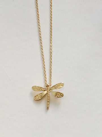 Gold dragonfly charm necklace with delicate chain.
