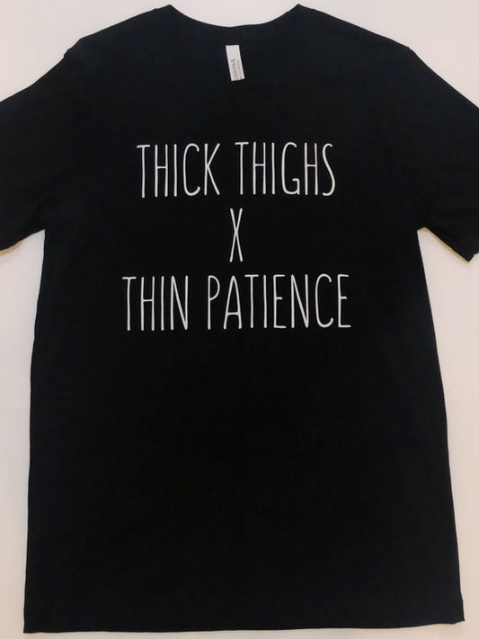 Black t-shirt featuring "Thick thighs x thin patience" in white lettering.