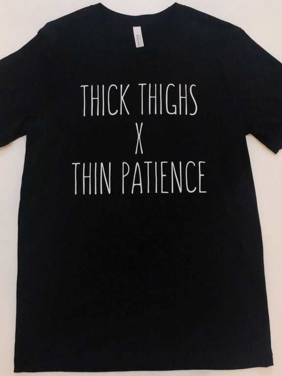 Black t-shirt featuring "Thick thighs x thin patience" in white lettering.
