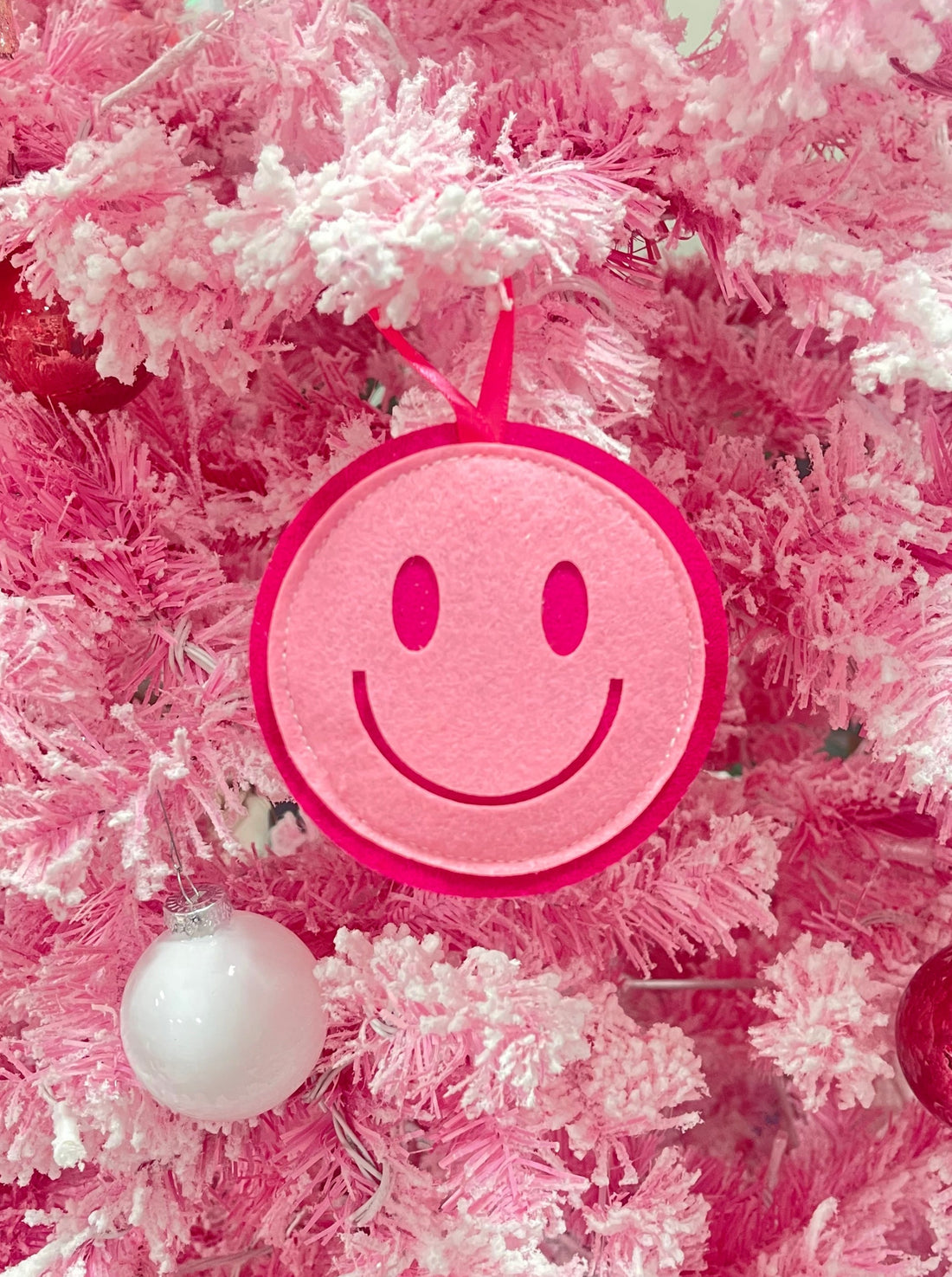 Pink felt Sassy Smiley Christmas ornament with hot pink trim
