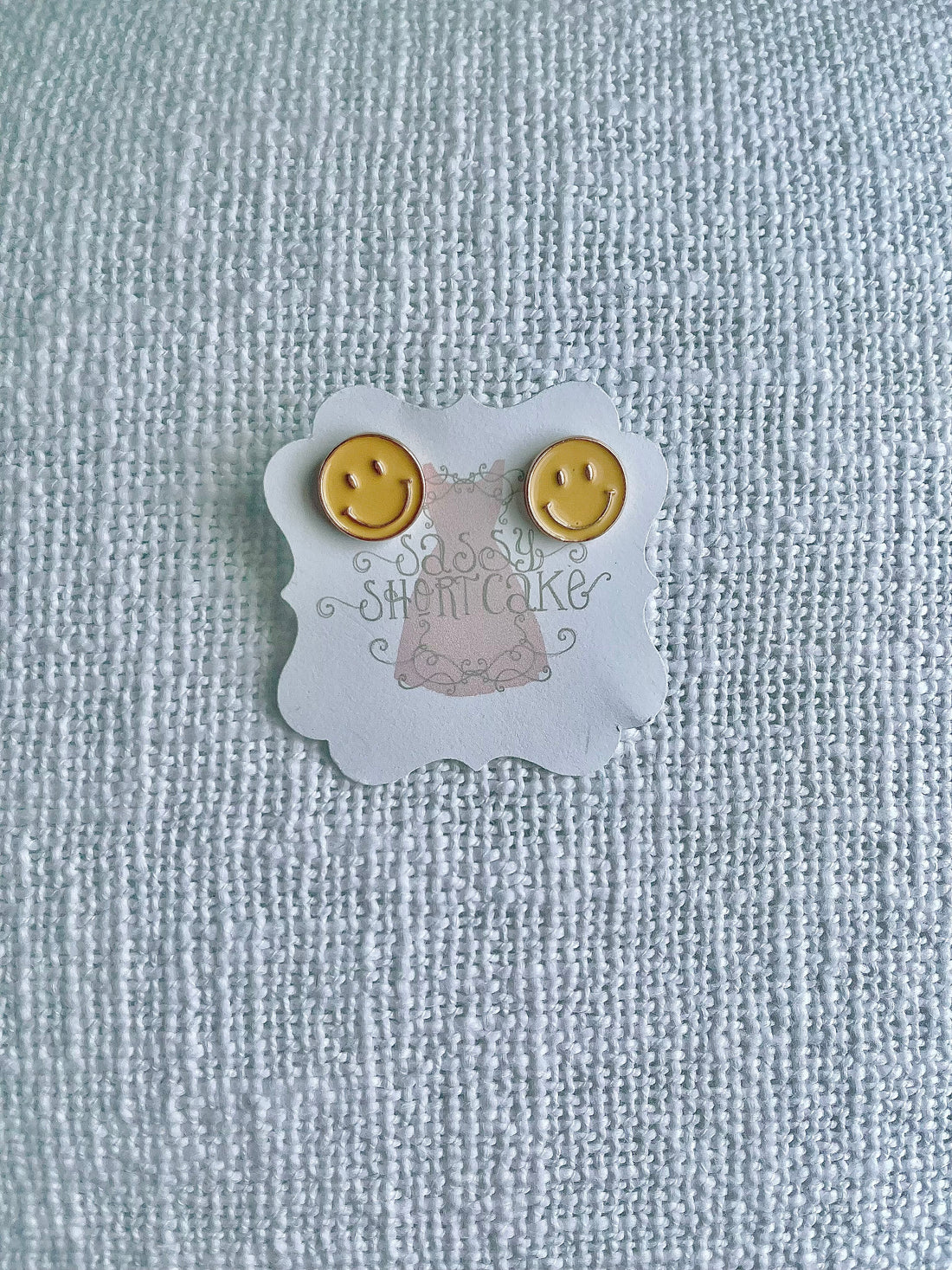 Sassy Shortcake Happy Face stud earrings: yellow smiley face design.
