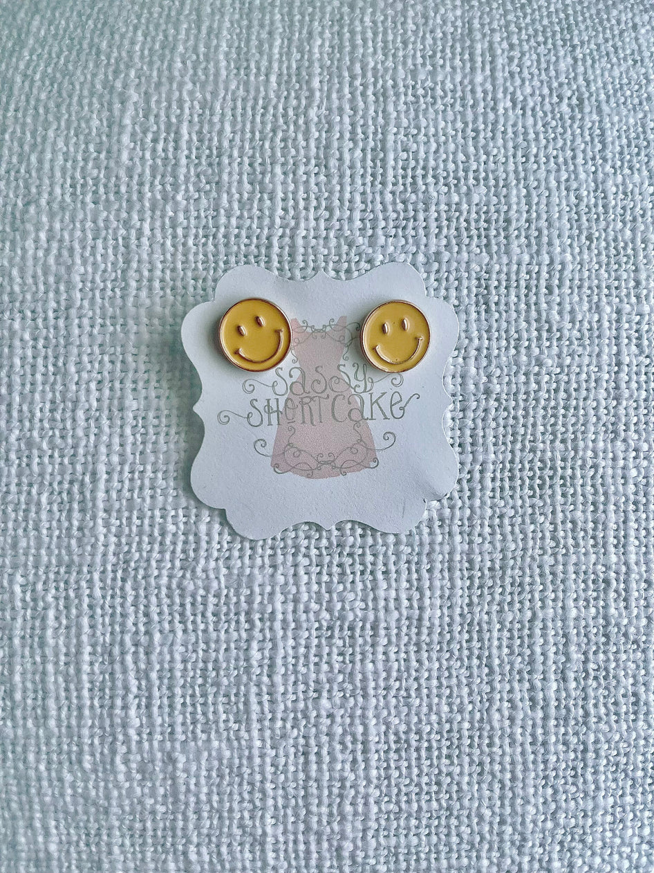 Sassy Shortcake Happy Face stud earrings: yellow smiley face design.
