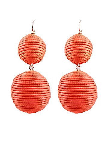Coral double-ball drop earrings with layered texture.
