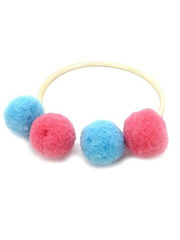 Gold bangle bracelet adorned with pink and light blue pom-poms.
