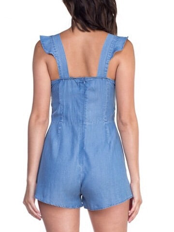 Light wash denim romper with ruffle straps; rear view.
