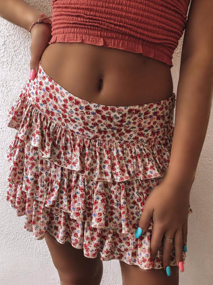 Floral print tiered mini skirt, cream base with red and blue flowers.

