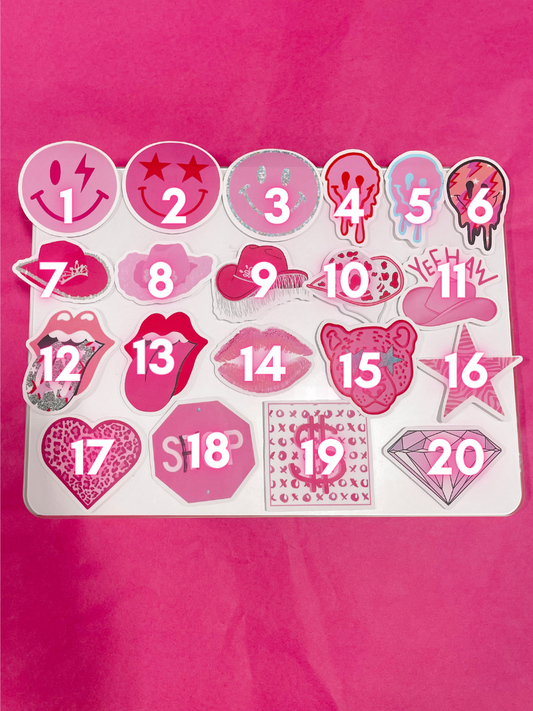 Twenty pink and white stickers, various designs, displayed on a pink background.
