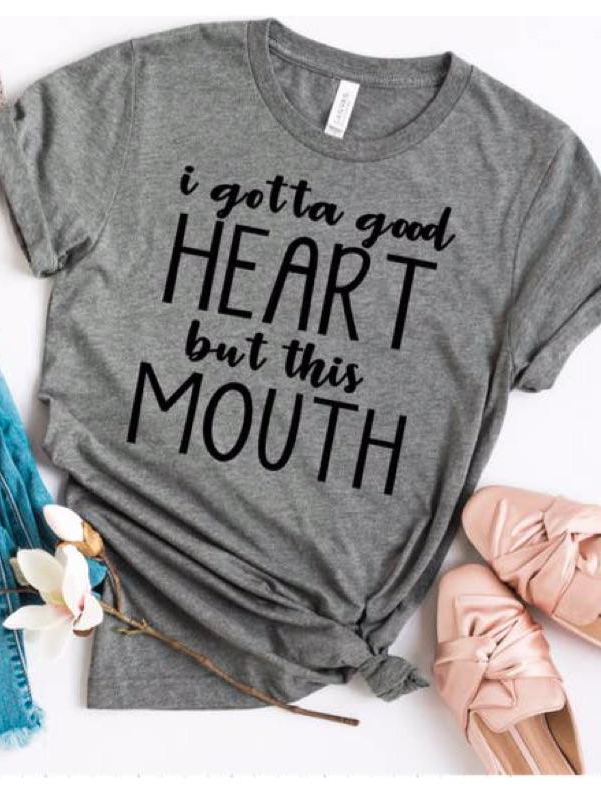 Gray "Truth Be Told" tee shirt featuring the phrase "I gotta good heart but this mouth" in black lettering.

