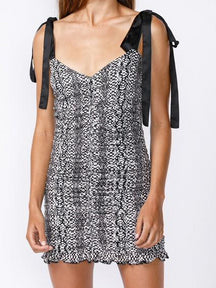 Black and white snakeskin print mini dress with black satin ribbon straps.
