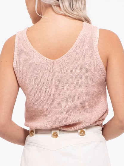 Back view of a blush pink knit tank top with a V-neck, shown on a model.
