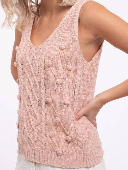 Pink cable knit Sweet Beauty tank top with delicate pom-poms.
